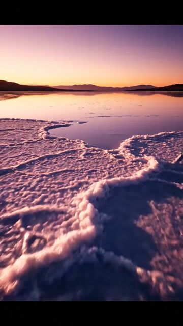 salt flat morphs into molten mirrored lake, glass surface swallowing stars